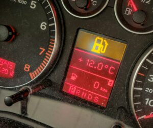 Closeup of a low fuel indicator on a car's dashboard