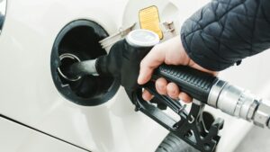 Hand puts fuel pump into car